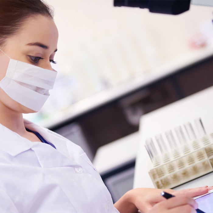 EU and UK cosmetic compliance specialist reviewing laboratory test samples and documentation.