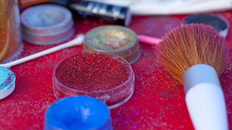 Cosmetic glitter pigments and coloured powders illustrating colourants, mica and glitter used in cosmetics under Annex IV regulations.