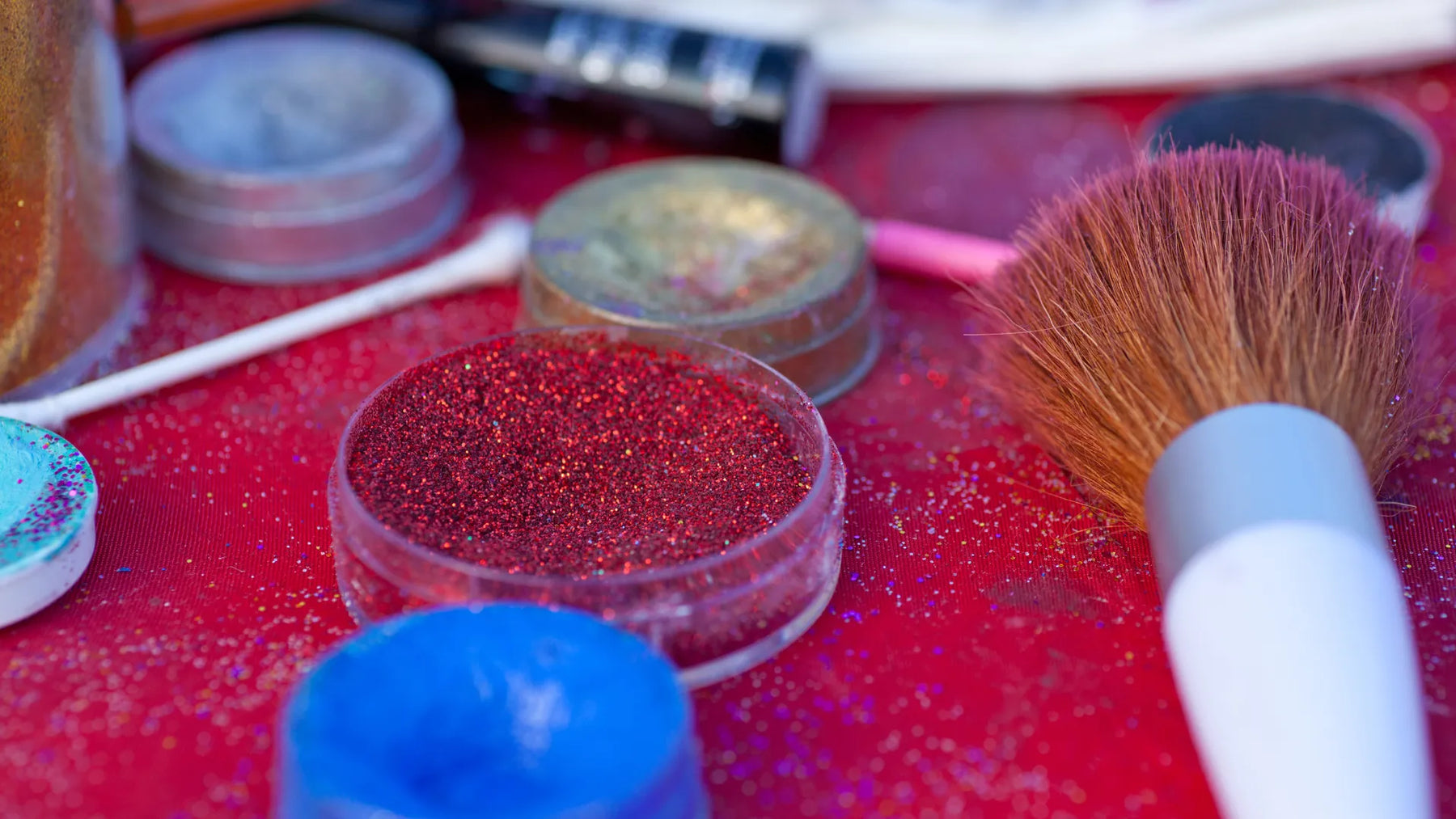 Cosmetic glitter pigments and coloured powders illustrating colourants, mica and glitter used in cosmetics under Annex IV regulations.