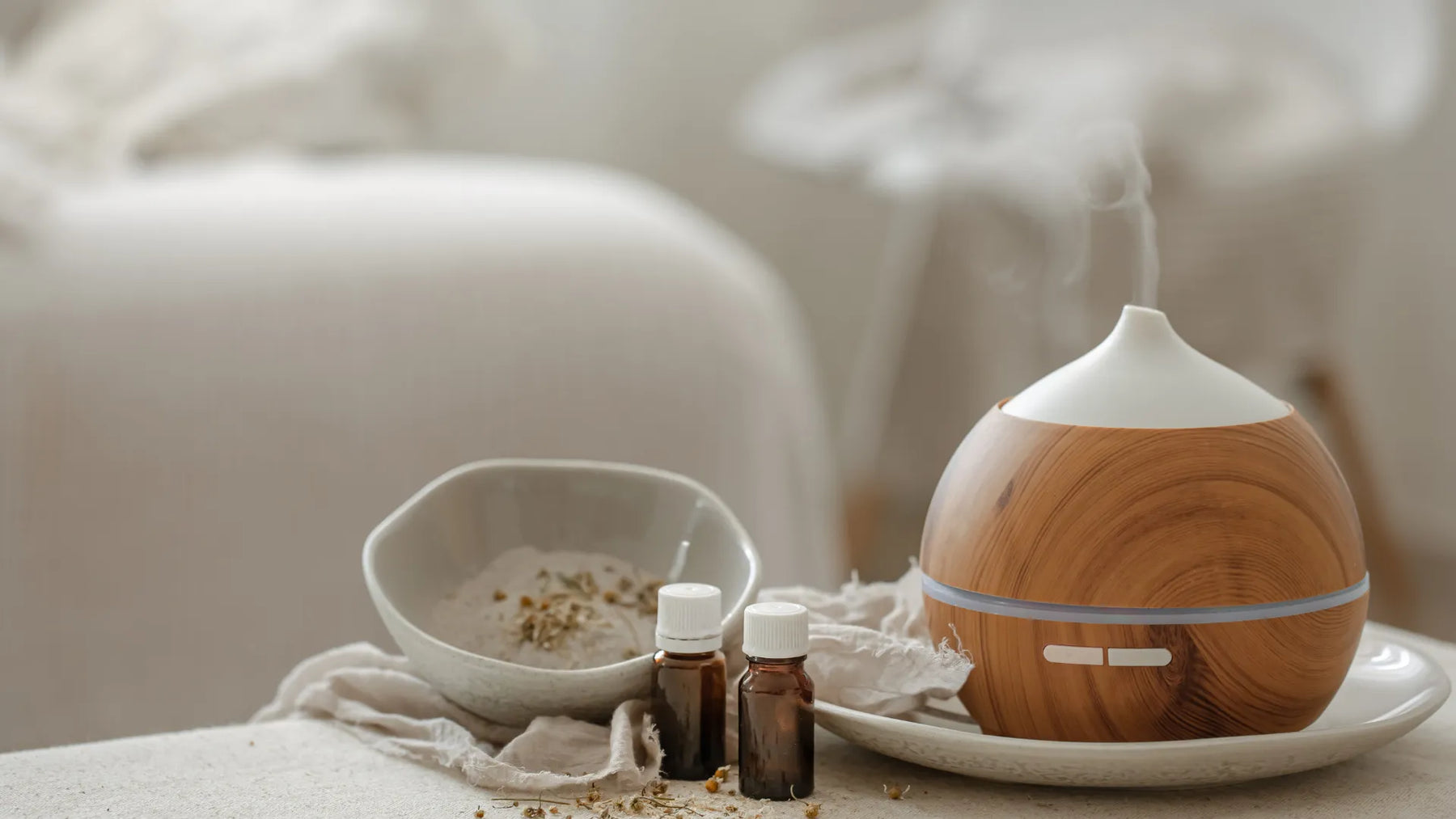 Essential oils and aroma diffuser displayed for fragrance safety assessment and UK and EU cosmetic compliance.