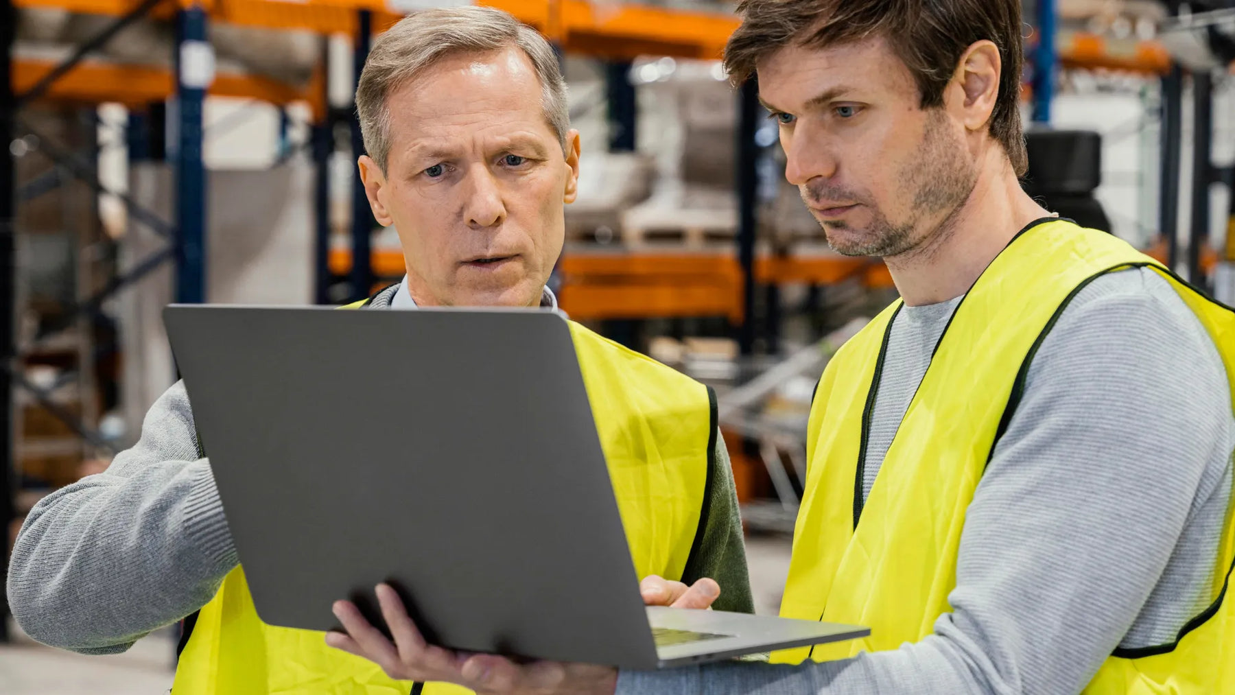 Warehouse staff reviewing Safety Data Sheets (SDS) to understand the differences between MSDS and SDS under the Globally Harmonized System (GHS) for UK product compliance.