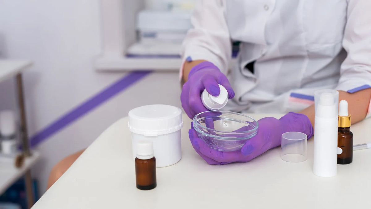 Formulator mixing skincare in a lab, illustrating toxicology and margin of safety in cosmetic safety assessment